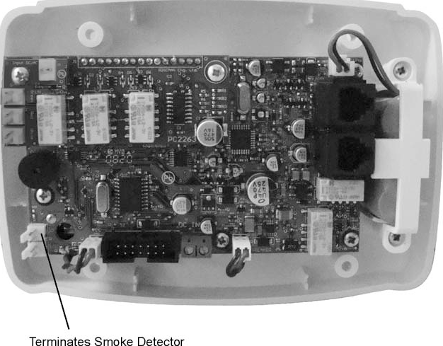 C-8  Installation C.7  Wiring a Smoke Detector The Resident Unit has a connector that supports a normally-open dry contact, such as a smoke detector.  The detector connects to the terminals marked JSW10, shown in the diagram below.  Note:  The Resident Unit should only be used as an ancillary notification device for smoke detectors.  Ensure that the smoke detector is connected to a code-approved alarming device.   